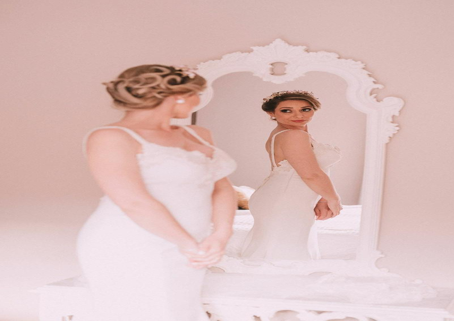 Bride posing in front of a mirror